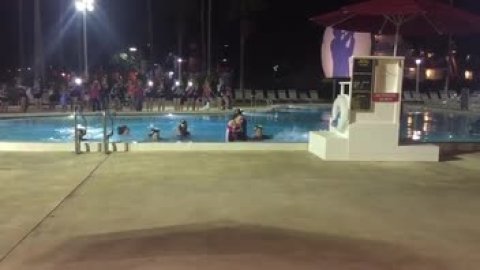 Junior-Seniors jumping in the pool after the Summit